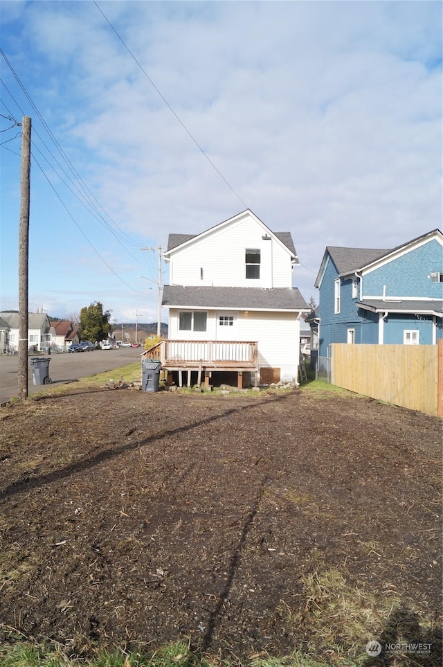 rear view of house featuring a wooden deck