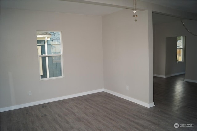 spare room with dark hardwood / wood-style floors