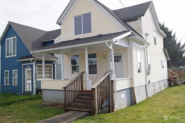 view of front of home with a front yard and covered porch