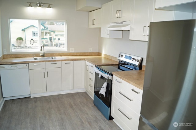 kitchen featuring stainless steel appliances, sink, light hardwood / wood-style flooring, and white cabinets