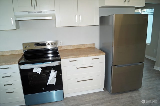 kitchen featuring stainless steel appliances, light wood-type flooring, and white cabinets