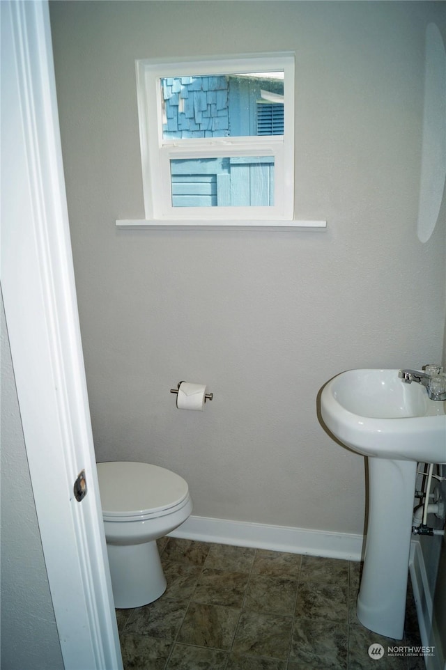 bathroom with tile patterned floors and toilet