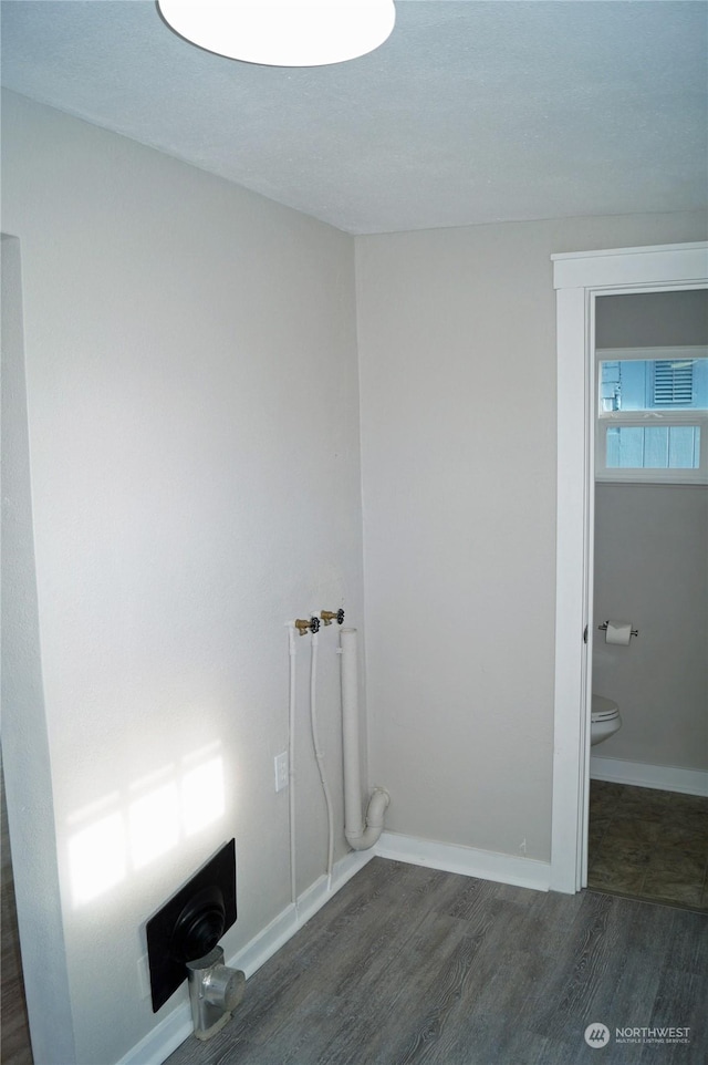 laundry area featuring dark wood-type flooring