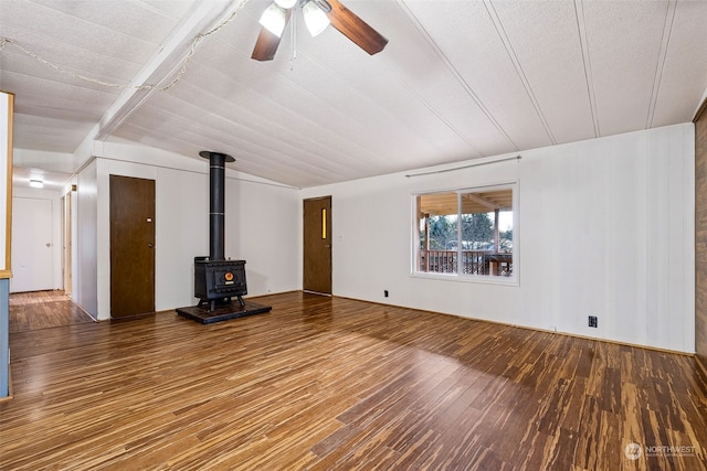 unfurnished living room with wood-type flooring, ceiling fan, and a wood stove