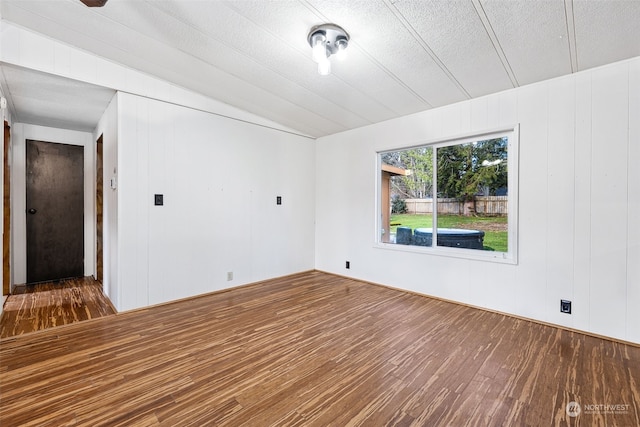 spare room featuring hardwood / wood-style flooring and a textured ceiling