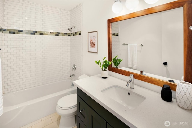 full bathroom featuring vanity, tiled shower / bath, toilet, and tile patterned floors