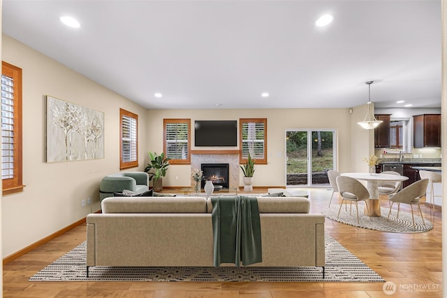 living room featuring sink and light hardwood / wood-style floors