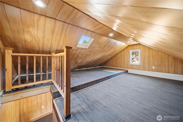 bonus room featuring dark colored carpet, wooden ceiling, vaulted ceiling, and wood walls