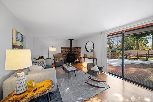 living room featuring a wood stove and hardwood / wood-style floors