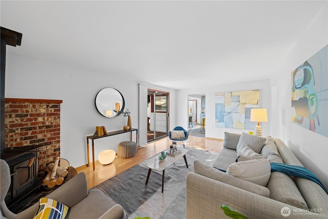 living room featuring hardwood / wood-style floors and a wood stove