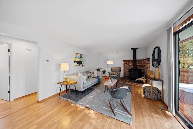 living room with hardwood / wood-style floors and a wood stove