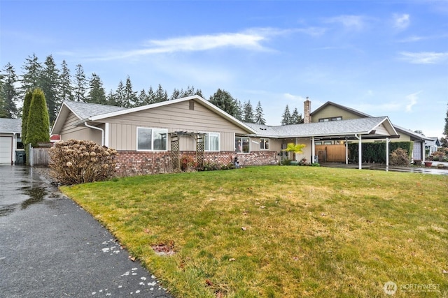 ranch-style home with brick siding and a front lawn