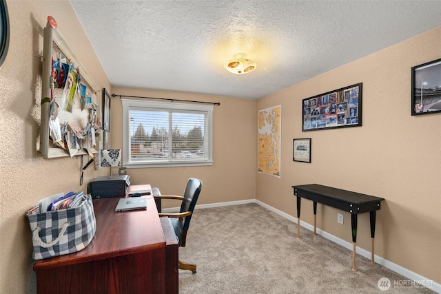 office area with light colored carpet, a textured ceiling, and baseboards