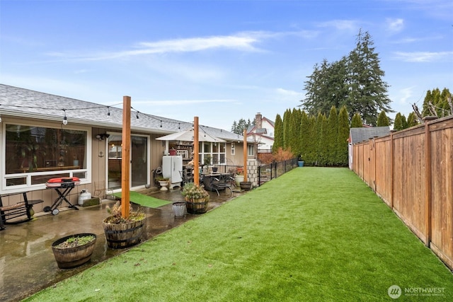 view of yard with a fenced backyard and a patio