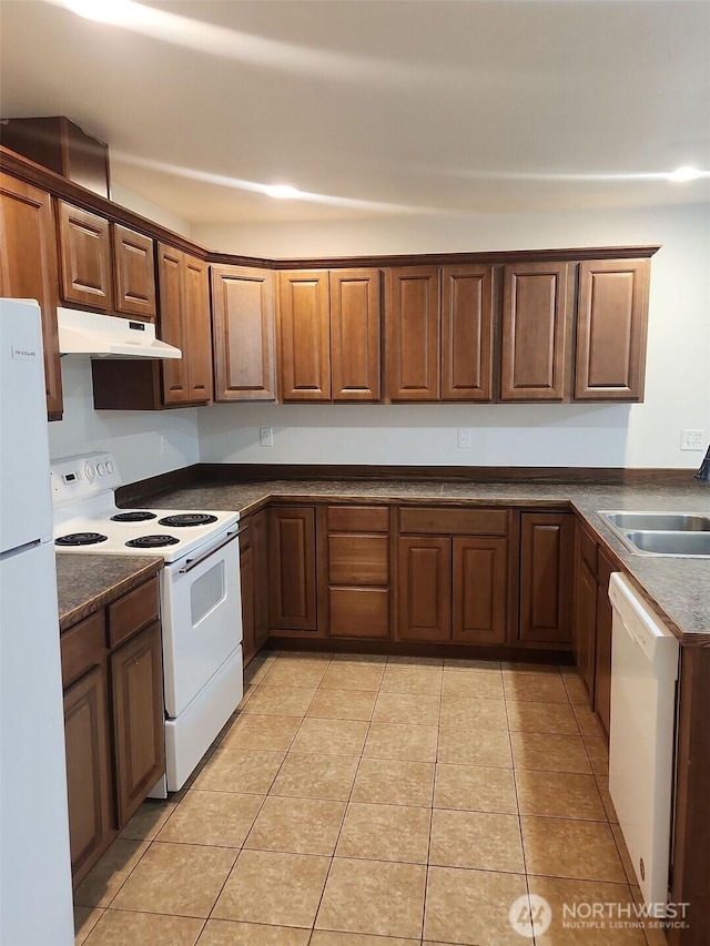 kitchen with sink, white appliances, and light tile patterned flooring