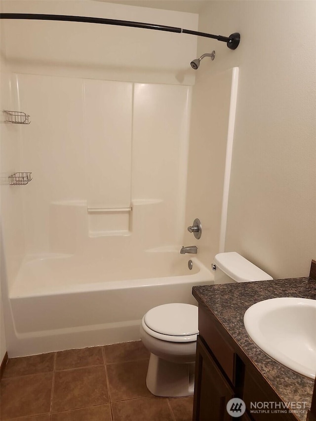 full bathroom with vanity, toilet,  shower combination, and tile patterned flooring