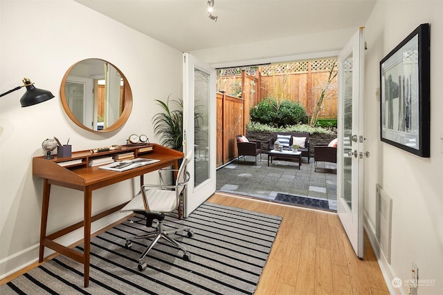 doorway with french doors and light hardwood / wood-style flooring