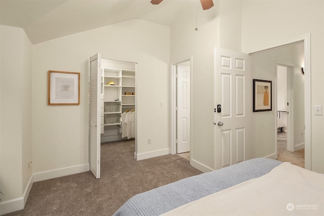 bedroom featuring vaulted ceiling, a walk in closet, carpet floors, and a closet