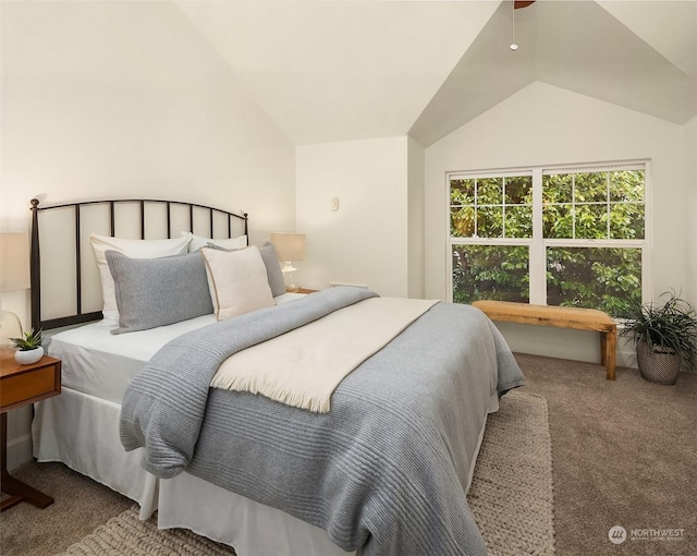 bedroom featuring ceiling fan, vaulted ceiling, and carpet