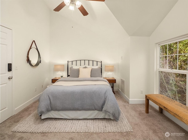 bedroom featuring high vaulted ceiling, light carpet, and ceiling fan