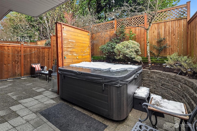 view of patio / terrace with a hot tub