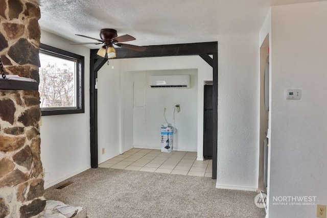 entryway with ceiling fan, light colored carpet, a wall unit AC, and a textured ceiling