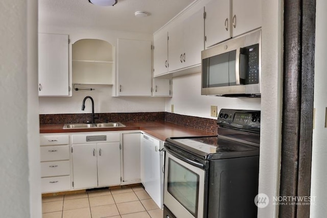 kitchen with appliances with stainless steel finishes, sink, and white cabinets