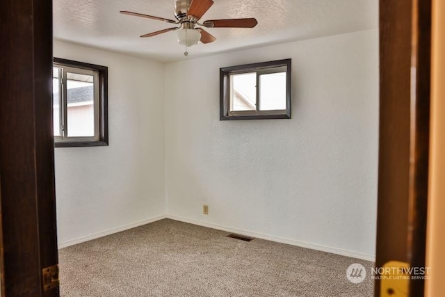 spare room with ceiling fan, carpet floors, and a textured ceiling