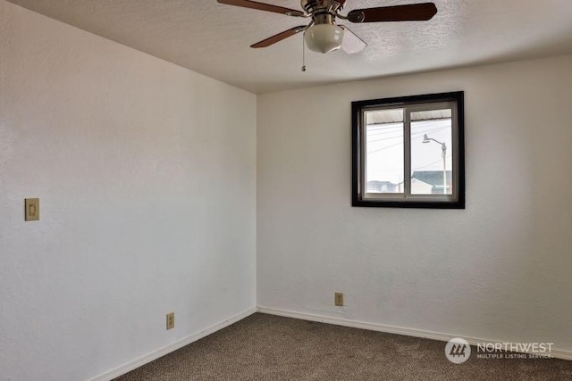 carpeted spare room with ceiling fan and a textured ceiling