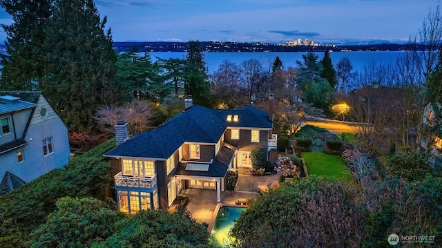 aerial view at dusk with a water view