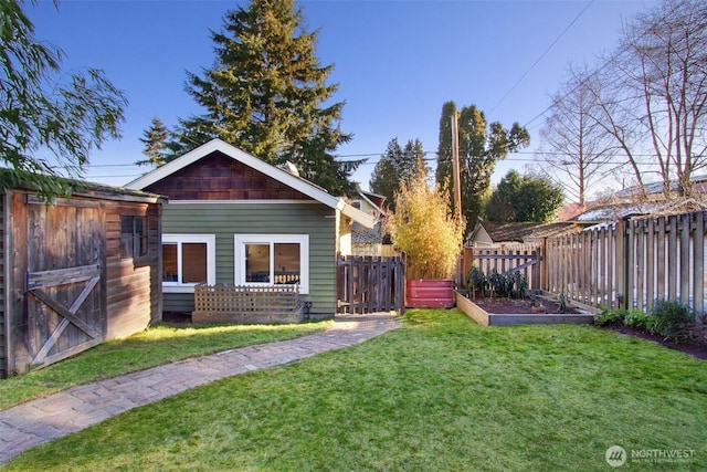 view of yard featuring fence and a vegetable garden