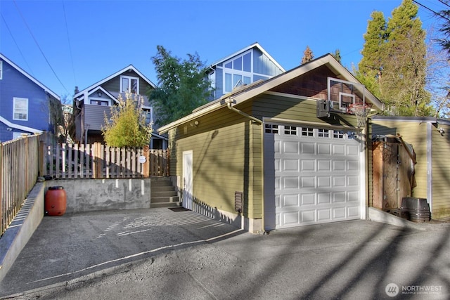 exterior space featuring driveway and fence