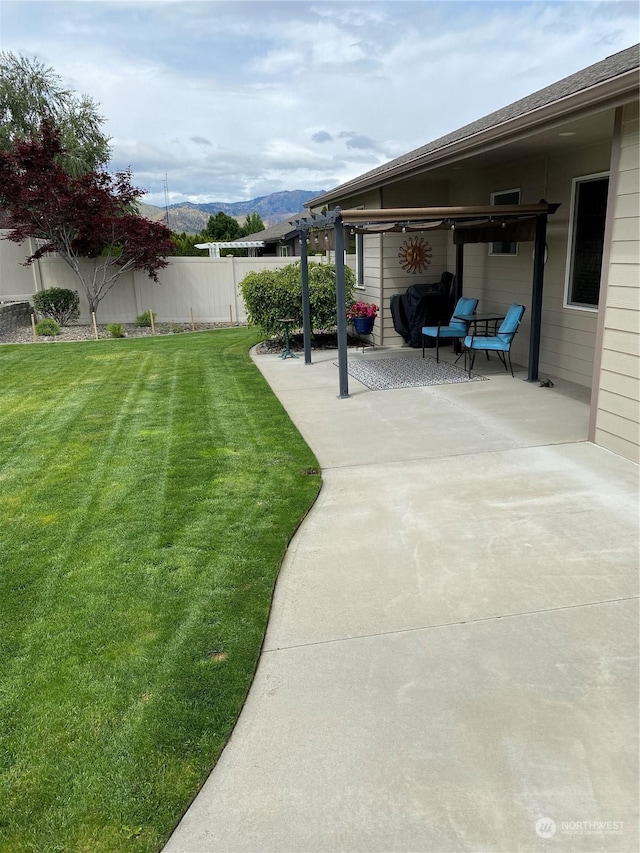 view of yard with a mountain view and a patio area