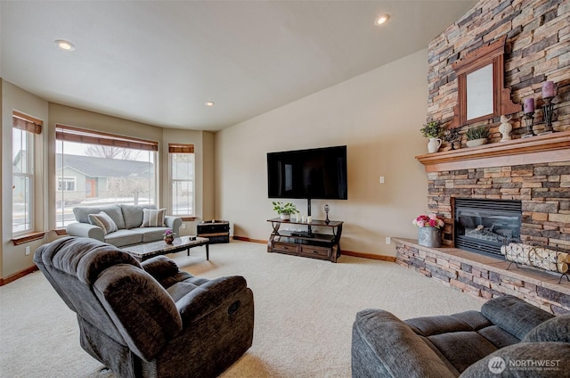 carpeted living room with a fireplace and lofted ceiling