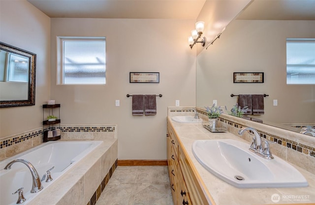 bathroom featuring tile patterned flooring, vanity, and a relaxing tiled tub