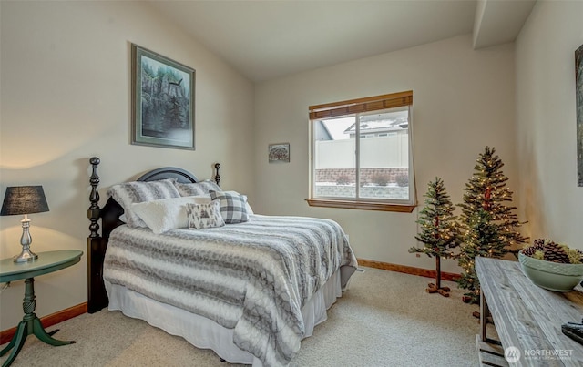 carpeted bedroom with lofted ceiling