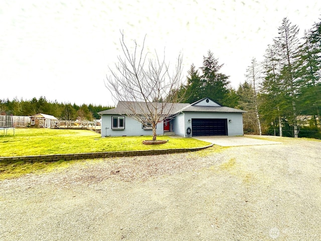 view of front of property with an attached garage, gravel driveway, fence, and a front yard