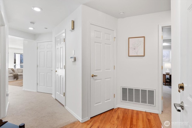 hallway with light carpet