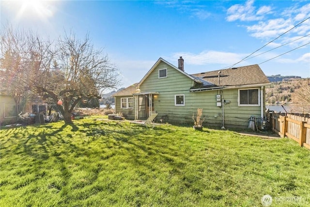 rear view of house with a lawn