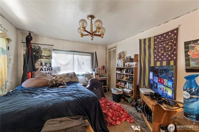 bedroom featuring carpet, a chandelier, and a closet