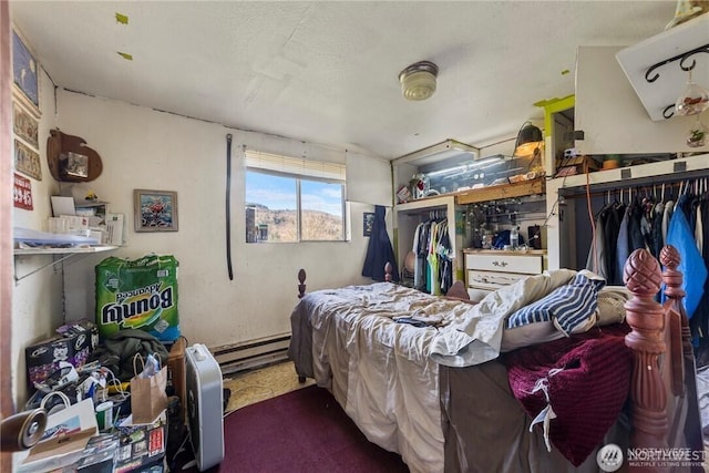 bedroom featuring a textured ceiling and baseboard heating