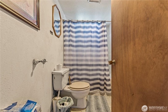 bathroom featuring tile patterned floors and toilet