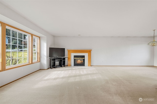 unfurnished living room with carpet flooring and a tile fireplace