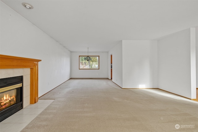 unfurnished living room featuring a fireplace and light colored carpet