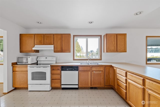 kitchen featuring white appliances and sink