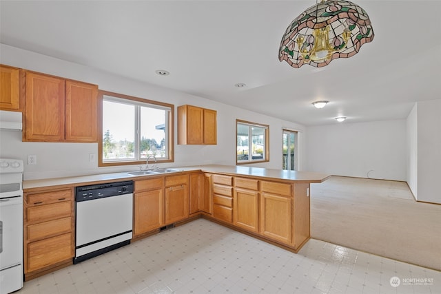 kitchen featuring extractor fan, pendant lighting, sink, kitchen peninsula, and white appliances