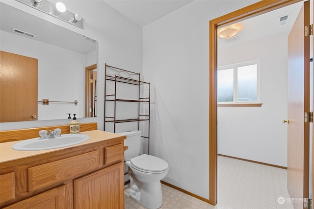 bathroom featuring vanity and toilet