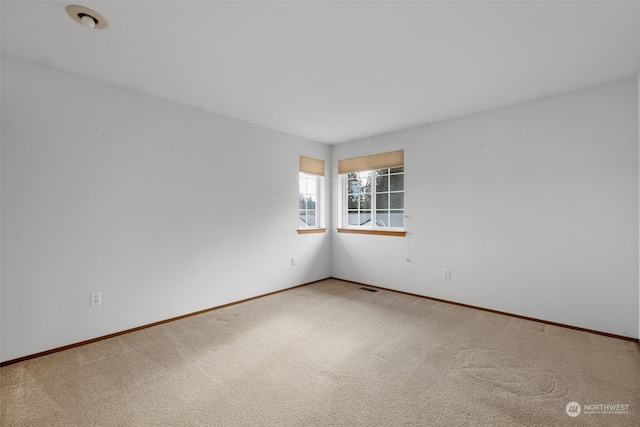 unfurnished room featuring carpet