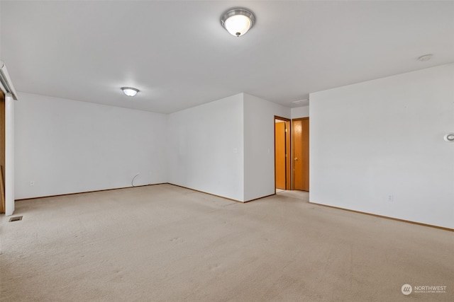 spare room with light colored carpet