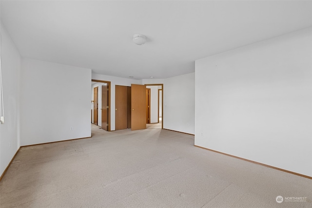 empty room featuring light carpet